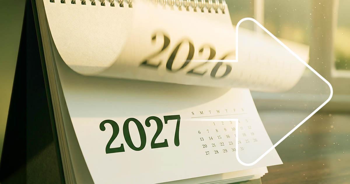 Decorative. A desktop calendar spiral bound along the top flips a page from 2026 to 2027.