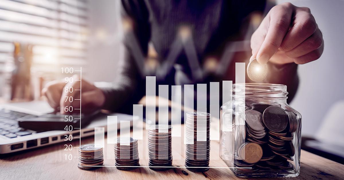 Decorative. Stacks of coins on a table with a torso and hand behind them. Superimposed over the image is a graphic of a bar graph indicating slow increase over time.
