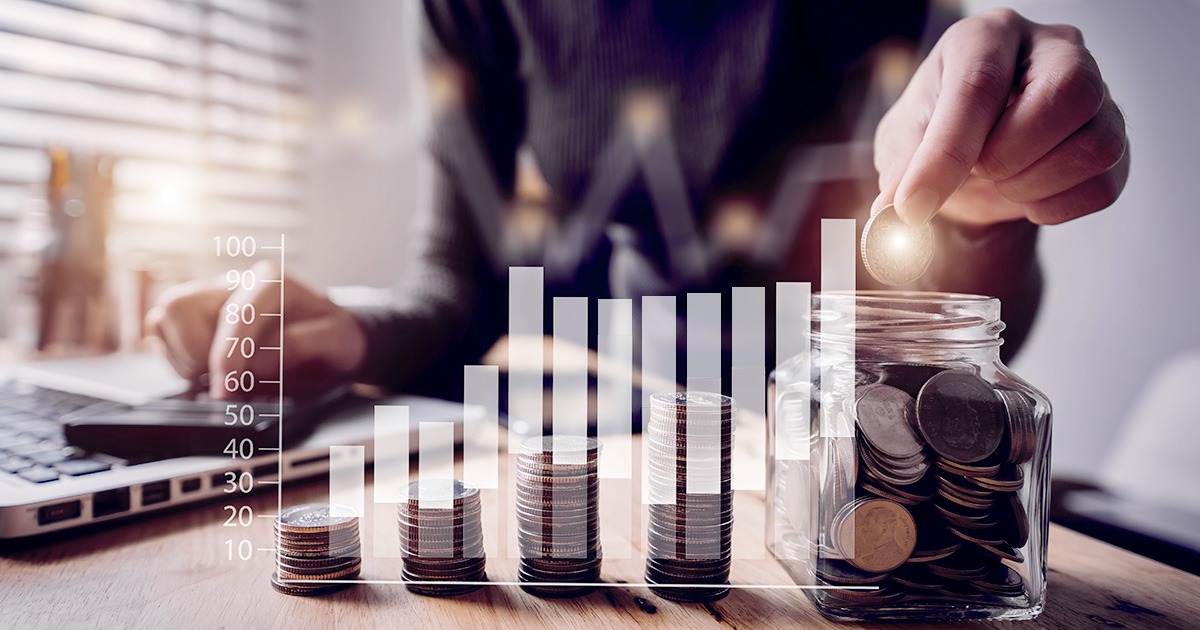 Decorative. Stacks of coins on a table with a torso and hand behind them. Superimposed over the image is a graphic of a bar graph indicating slow increase over time.