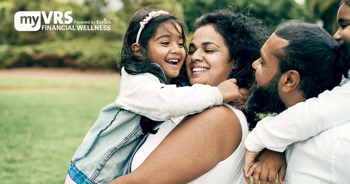 A smiling family embraces outdoors. The myVRS Financail Wellness logo is on the left. In the background is a lawn and leafy trees. Illustrative only.