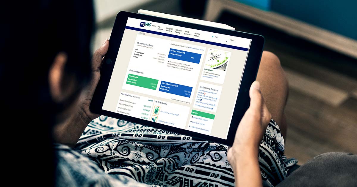 An over-the-shoulder view of a man looking at a computer tablet in his hands. On the screen of the tablet is the myVRS website. Illustrative only.