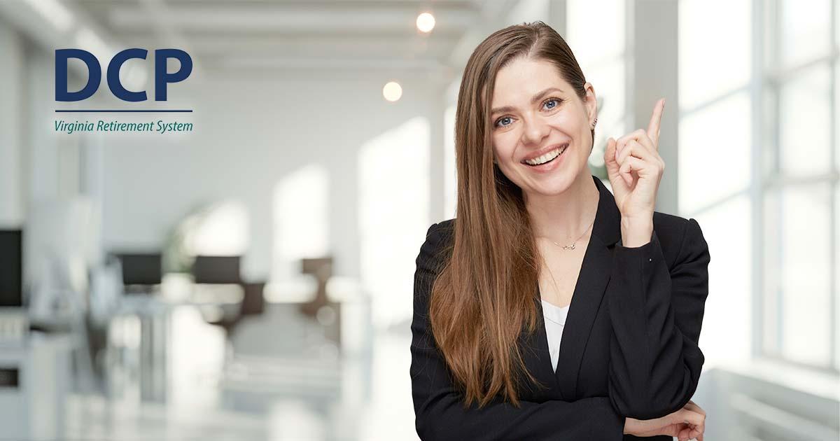 A smiling woman in professional dress in the right of the frame points upward with her left index finger. A muted and blurred office interior is behind her. In the upper left corner of the frame is the DCP logo.